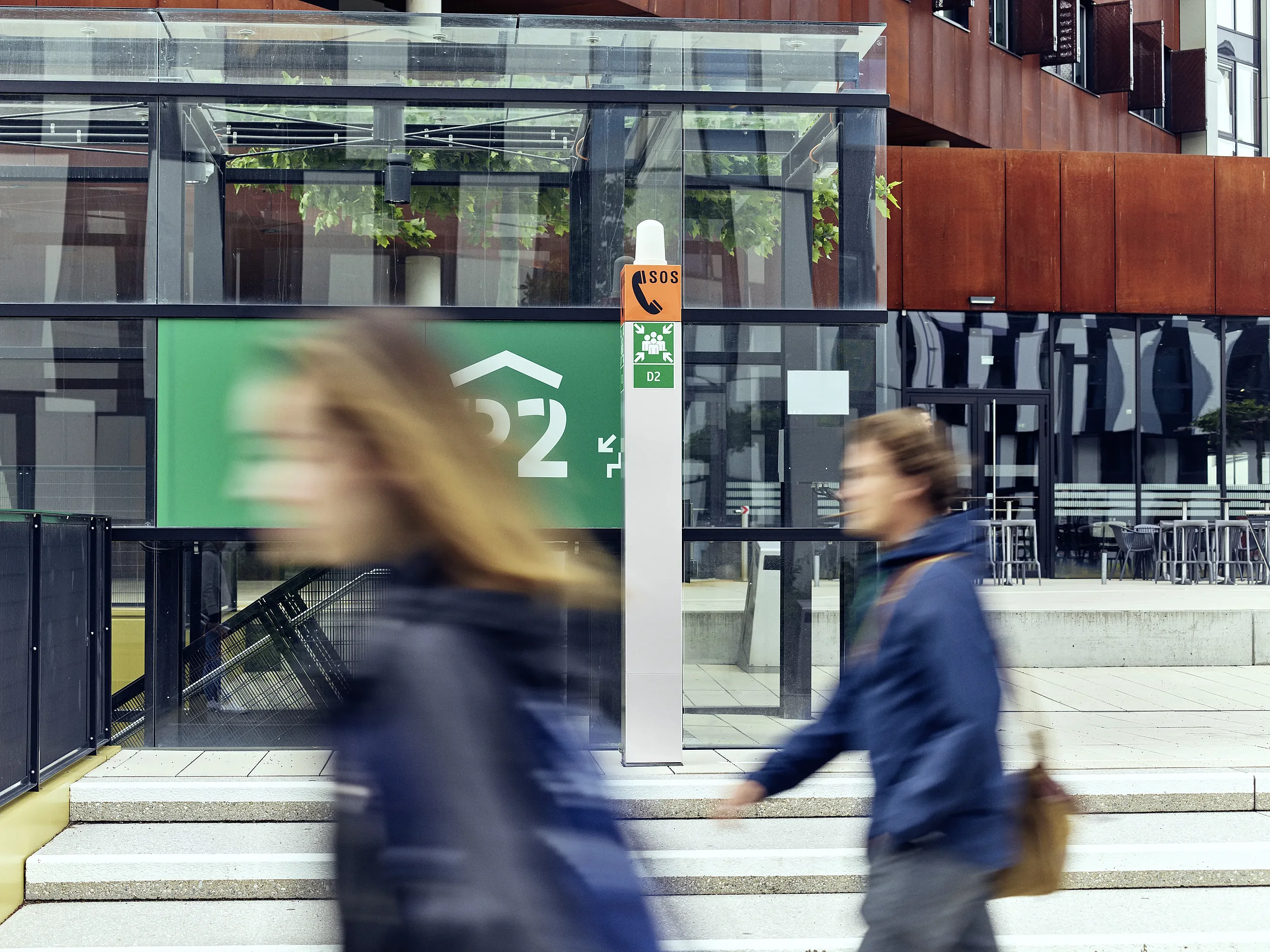 Outdoor Intercom security solution at building entrance Emergency Intercom station near modern building with people walking by