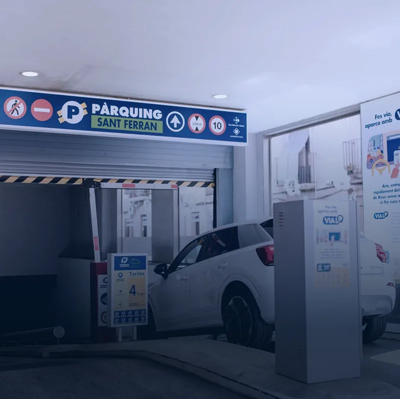 Car entering Sant Ferran parking with ticket machine Car at Sant Ferran parking entrance beside ticket machine