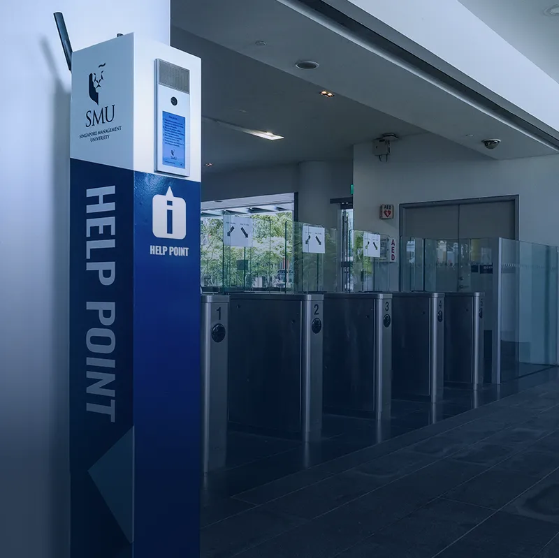Campus help point and secure entrance with electronic access gates University help point next to electronic access gates providing secure entry and visitor assistance